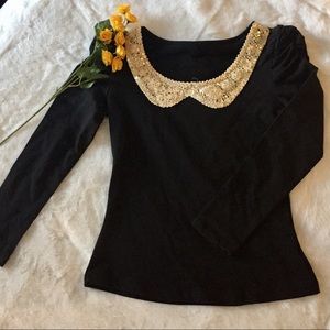 Girl’s black formal blouse with gold collar.